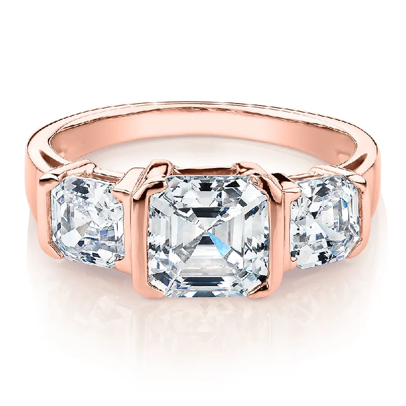 Three stone ring with 3.38 carats* of diamond simulants in 10 carat rose gold