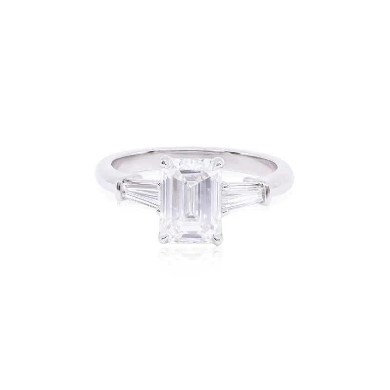 PLATINUM HENNE-FIT EMERALD-CUT DIAMOND AND TAPERED BAGUETTE THREE-STONE ENGAGEMENT RING