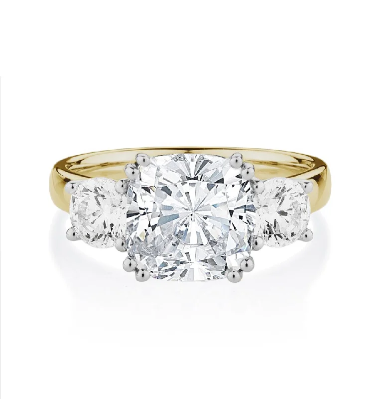 Three stone ring with 3.75 carats* of diamond simulants in 10 carat yellow and white gold