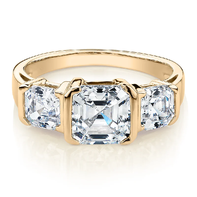 Three stone ring with 3.38 carats* of diamond simulants in 10 carat yellow gold