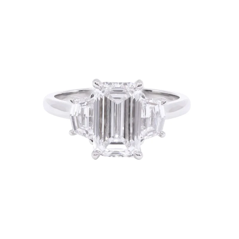 PLATINUM HENNE-FIT THREE-STONE EMERALD-CUT DIAMOND ENGAGEMENT RING WITH CADILLAC-CUT SIDE DIAMONDS